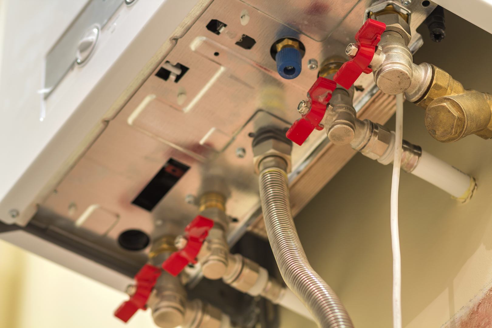 Gas water heater boiler for home heating, bottom view. Installation, connection and maintenance concept.