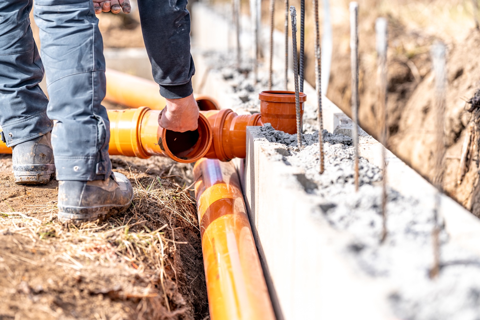 installation of a sewage plastic pipe during the construction of a house.